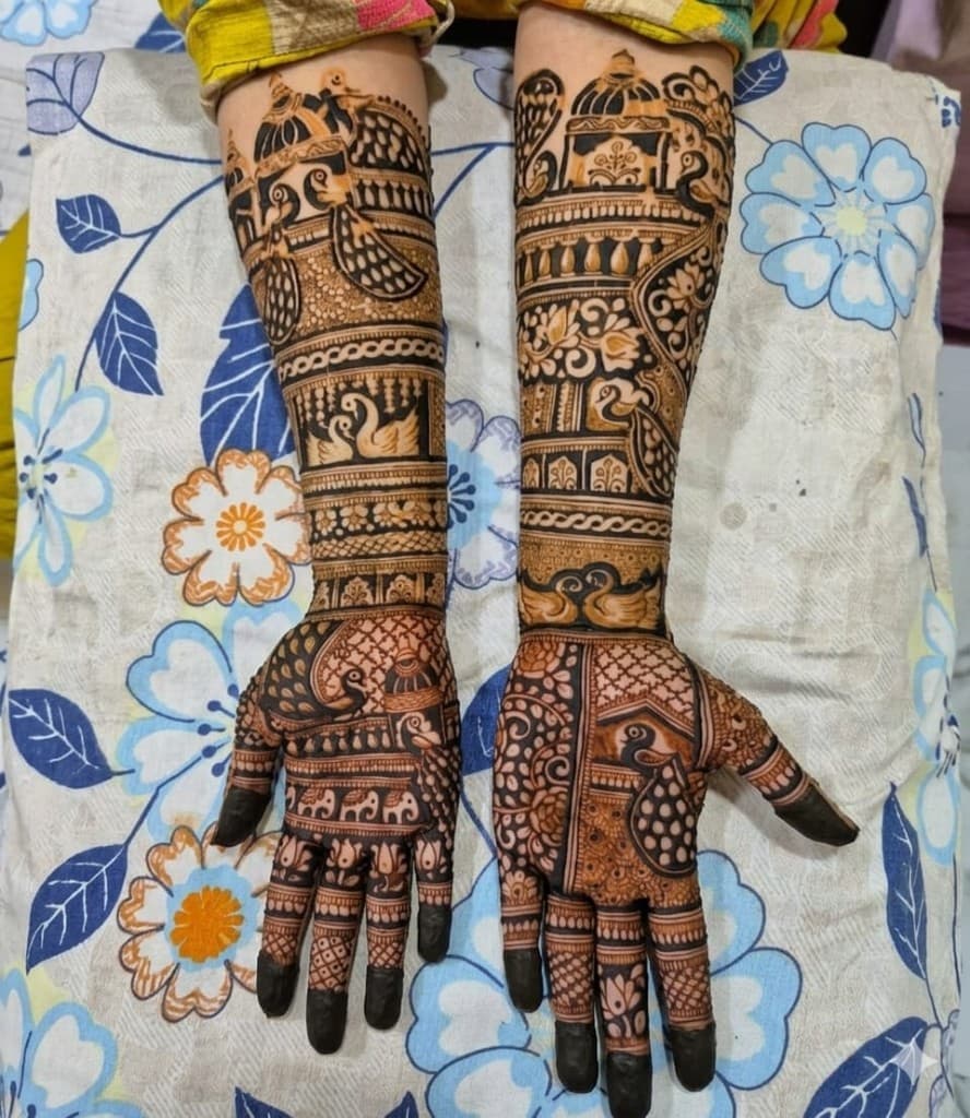 Peacock and swan full-arm bridal mehndi